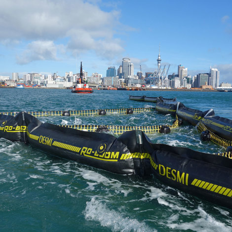 DESMI RO-BOOM in water with city skyline in the background.
