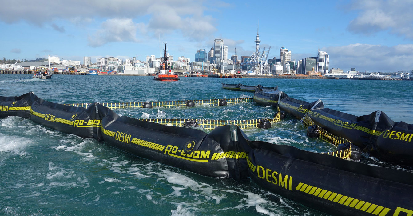 DESMI RO-BOOM in water with city skyline in the background.