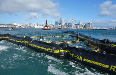 DESMI RO-BOOM in water with city skyline in the background.