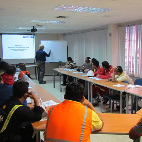 Classroom training session on oil spill response methods with diverse participants.