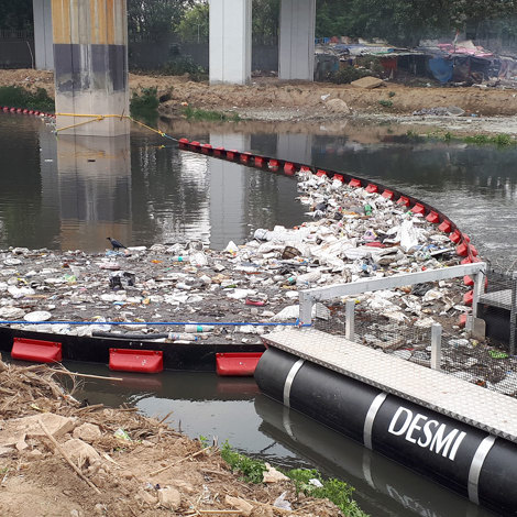 Child holding a clear glass of water with both hands.