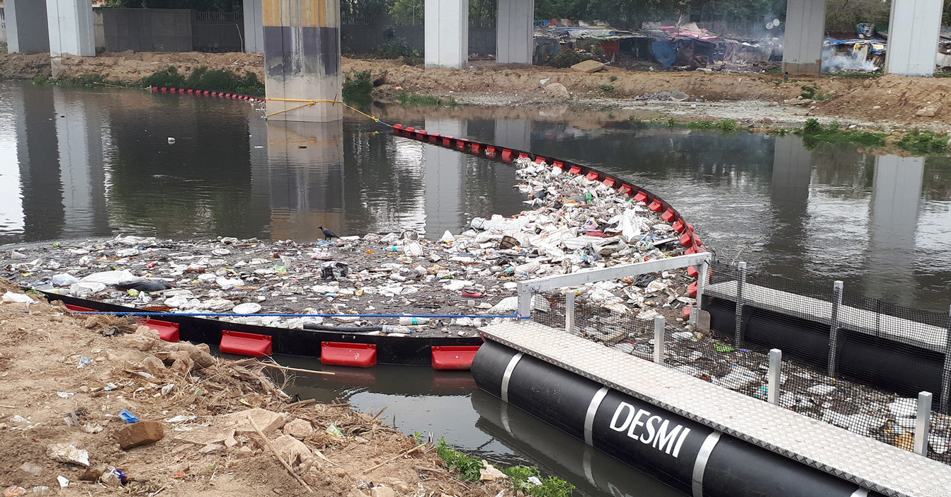Child holding a clear glass of water with both hands.