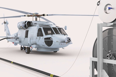 Helicopter refueling from a hose reel system in a hangar setting.