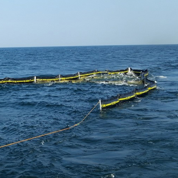 DESMI oil containment boom in ocean, managing spill control and cleanup efforts.