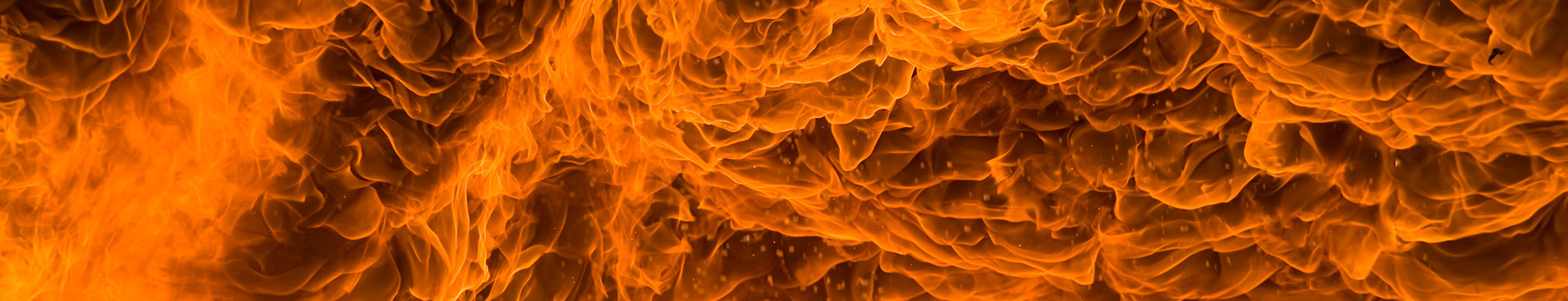 Vivid, swirling flames creating a dynamic, fiery pattern in orange and yellow hues.