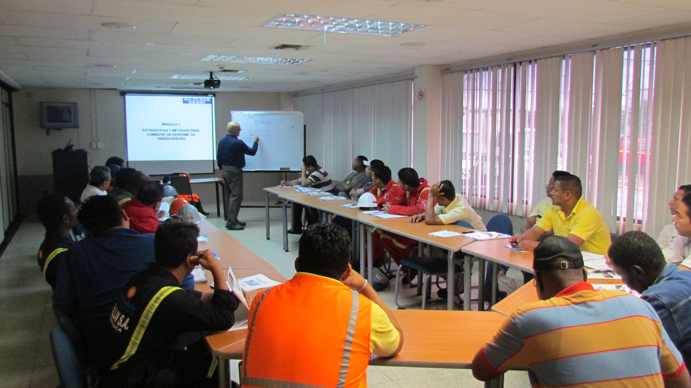 Training session on hydrocarbon spill response with participants in a conference room.