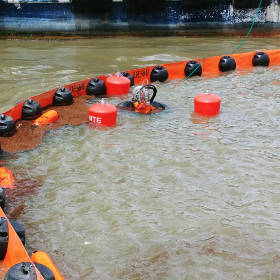 DESMI oil containment boom deployed in water for spill control and cleanup.