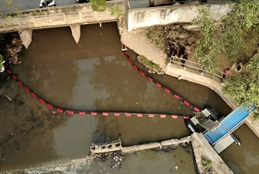 DESMI systems capturing aquatic plants and debris in a waterway for fluid handling.