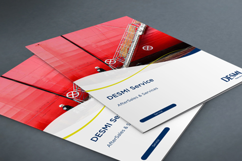 DESMI DeServe brochures featuring aftersales and services on a gray surface.