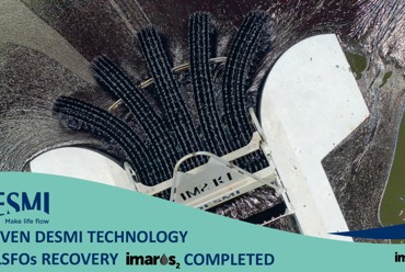 DESMI oil spill recovery skimmer operating in water with visible oil slick.